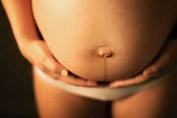 A pregnant woman holding her stomach