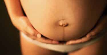 A pregnant woman holding her stomach