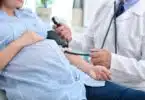 pregnant woman getting her blood pressure taking