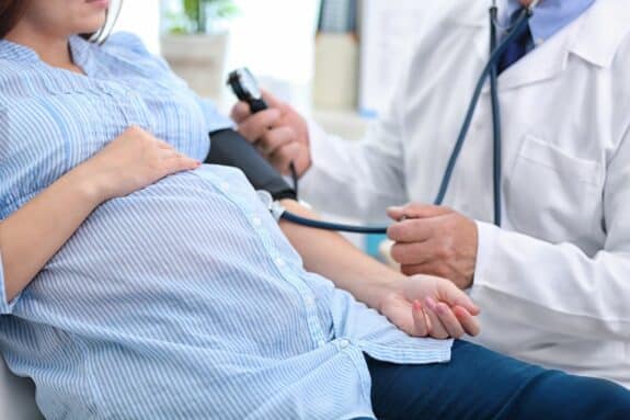 pregnant woman getting her blood pressure taking
