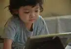 toddler in front of ipad
