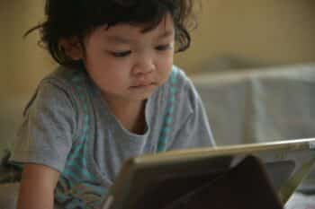 toddler in front of ipad