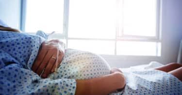 Close-up of a pregnant woman's belly in hospital