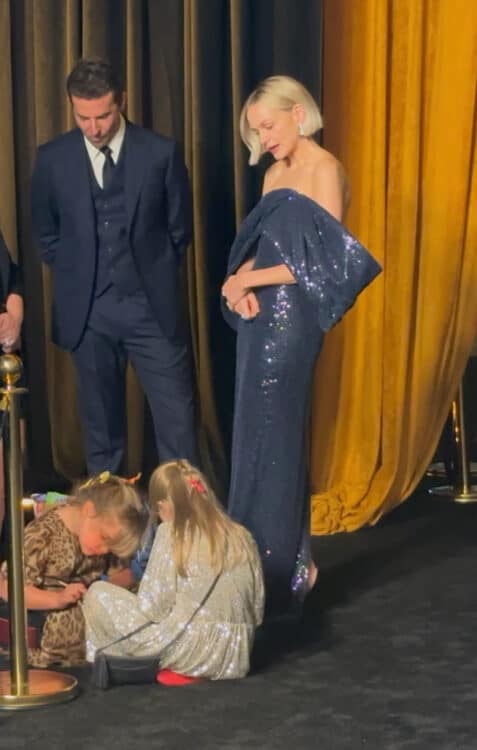 Bradley Coopers daughter enjoys some time COLORING at the MAESTRO premiere as her famous dad chats with costar Carey Mulligan in LA