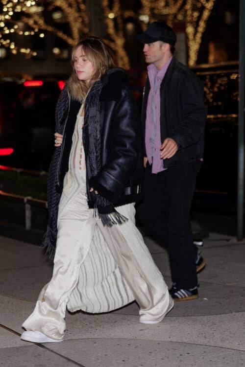 Pregnant Suki Waterhouse and Robert Pattinson leave the DGA theater to attend the Poor Things movie premiere after party