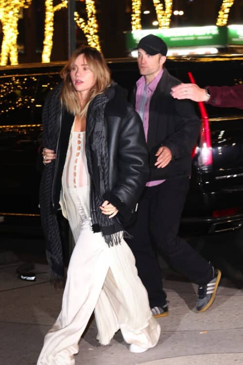 Pregnant Suki Waterhouse and Robert Pattinson leave the DGA theater to attend the Poor Things movie premiere after party