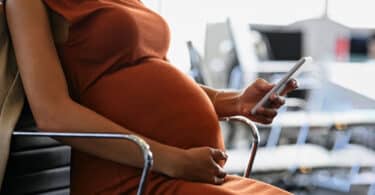 Pregnant woman using her phone