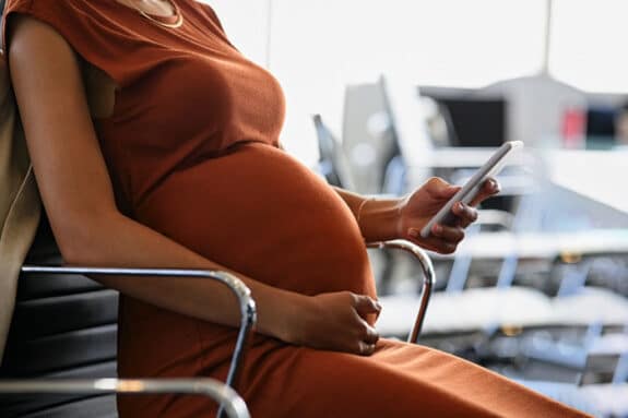 Pregnant woman using her phone