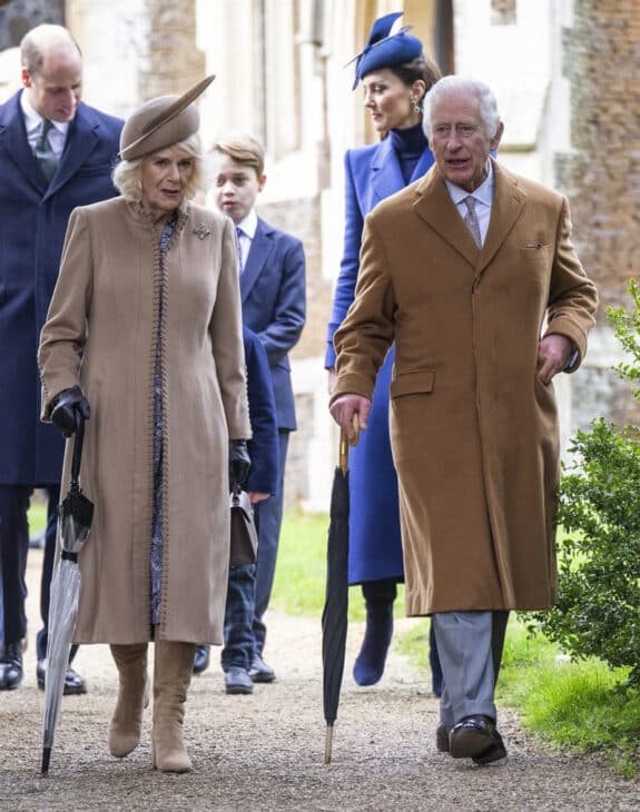 The king and queen walked side by side as they headed into the church