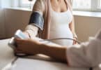 Doctor measuring blood pressure of her pregnant patient