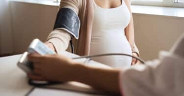 Doctor measuring blood pressure of her pregnant patient