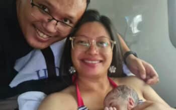New parents Keith and Gill Bay pictured with their son Nathanael in an ambulance on the way to Waita?kere Hospital