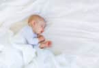 child sleeping in bed