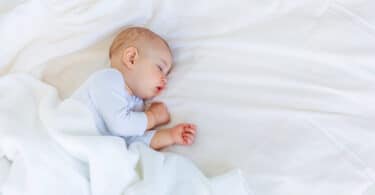 child sleeping in bed