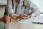 Shot of a doctor showing a patient some information on a digital tablet