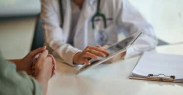 Shot of a doctor showing a patient some information on a digital tablet