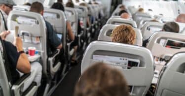 Interior of commercial airplane with passengers in their seats