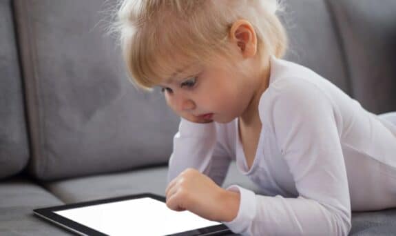 toddler playing with their iPad