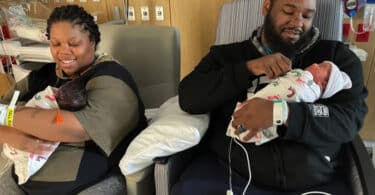 Angelia Tutt and husband Elliott McNeil holding their newborn twins