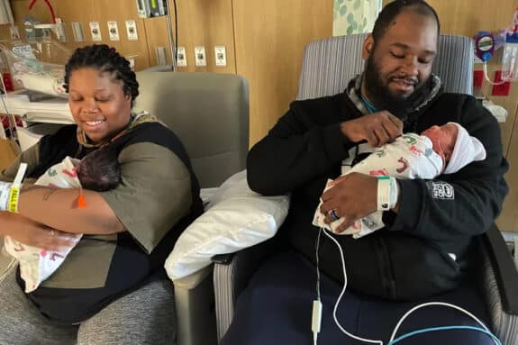 Angelia Tutt and husband Elliott McNeil holding their newborn twins