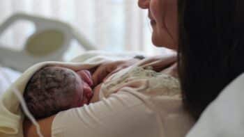 Newborn baby with mother breastfeeding