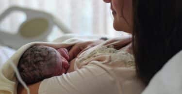 Newborn baby with mother breastfeeding