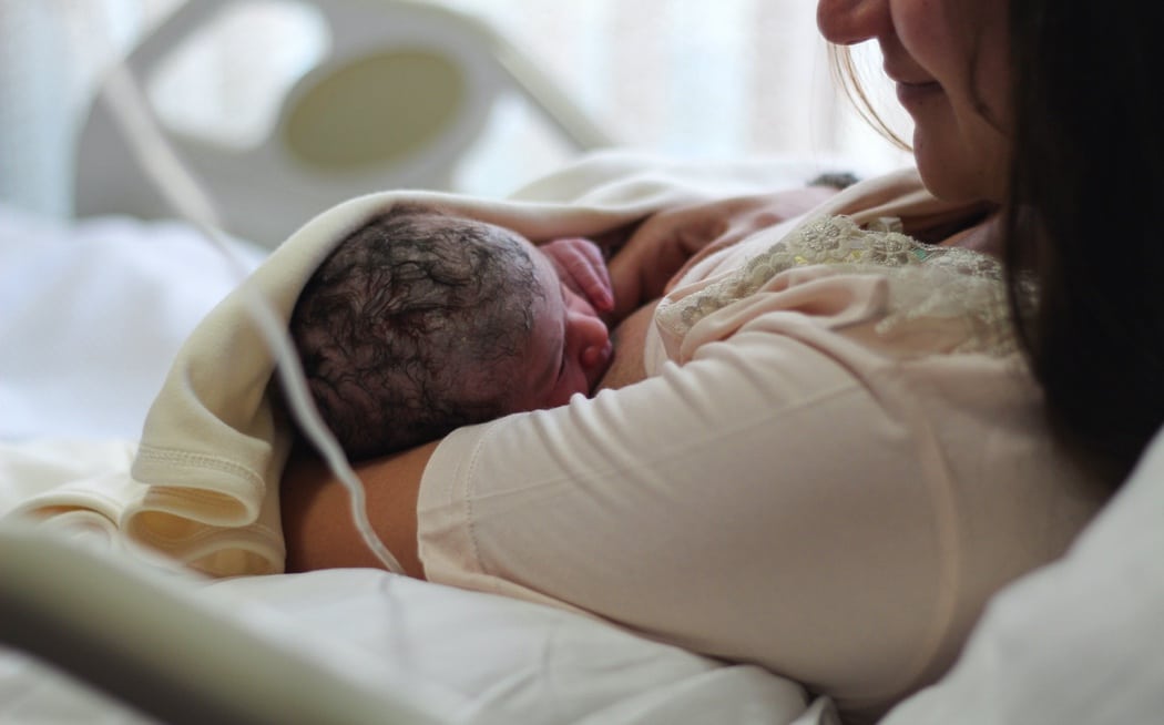 Newborn baby with mother breastfeeding