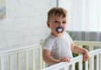baby boy with pacifier in baby crib