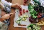 pregnant woman chopping vegetables for meal