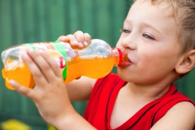 child drinking soda