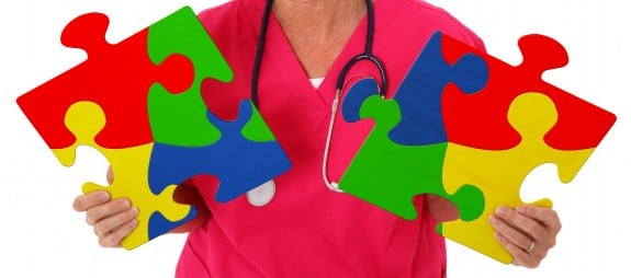 Nurse Holding Two Puzzle Pieces Representing Autism Awareness