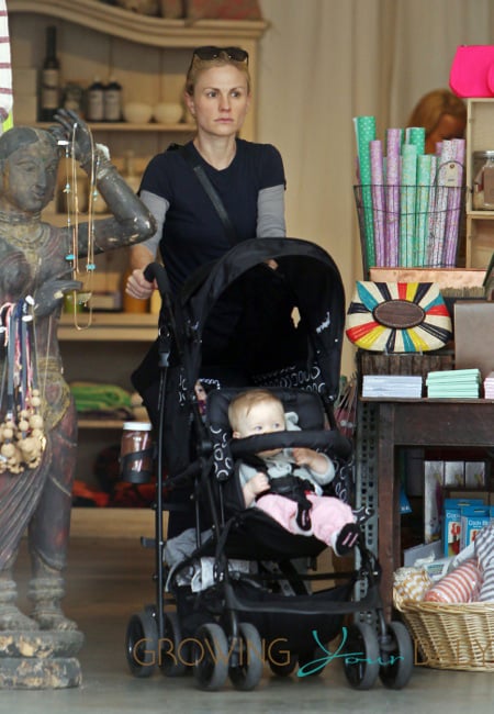 Anna Paquin pulls double duty with one of her twins in a harness and the other in a stroller while walking in Los Angeles