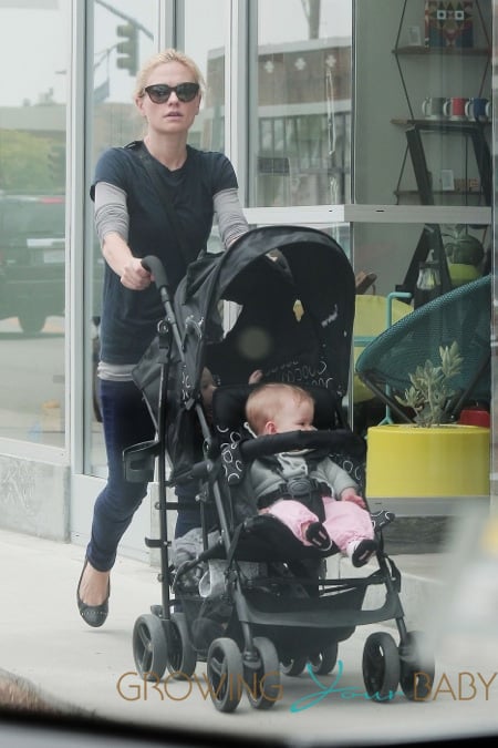 Anna Paquin pulls double duty with one of her twins in a harness and the other in a stroller while walking in Los Angeles