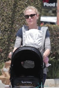Anna Paquin pulls double duty with one of her twins in a harness and the other in a stroller while walking in Los Angeles