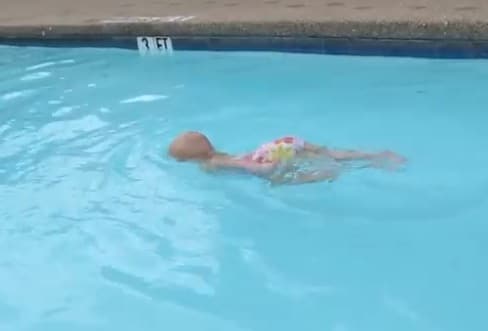 Baby Elizabeth swims the length of the pool