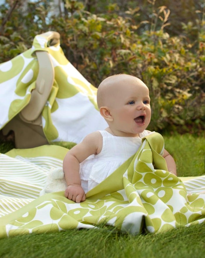 Baby sitting on an Oilo Play Blanket