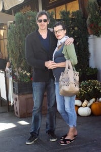 Milla Jovovich showing off a large baby bump in a tight tank top as she and her husband Paul W