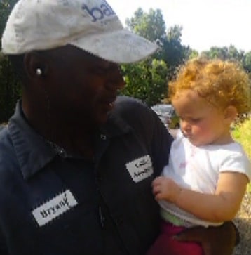 Bryant Collins with the toddler he saved