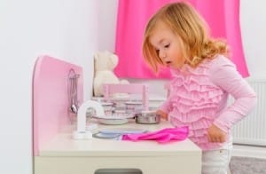 Child playing with her kitchen