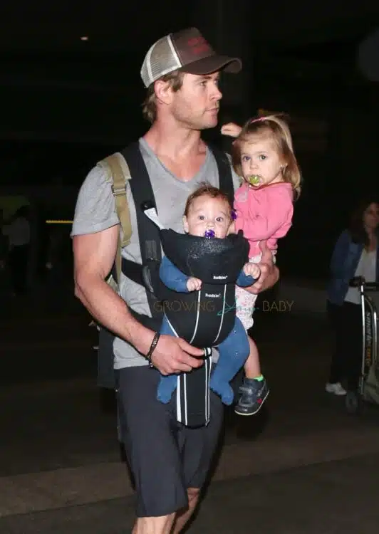 Chris Hemsworth carries his daughter India and son at LAX