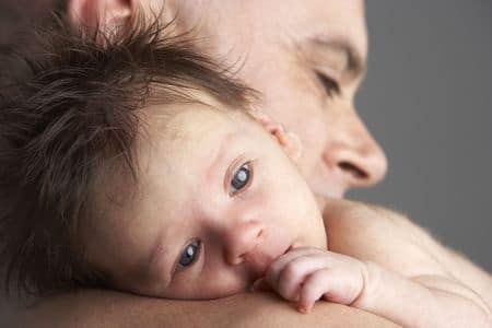 Dad cuddling baby