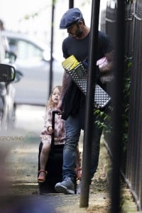David Beckham pulls Harper on his suitcase