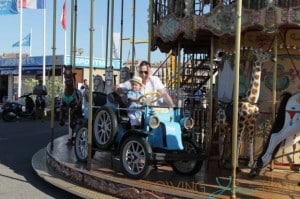 David Furnish rides the carousel with his son Zachary