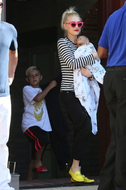 Gwen Carries her son Apollo to the car after Joel Silver's memorial day party
