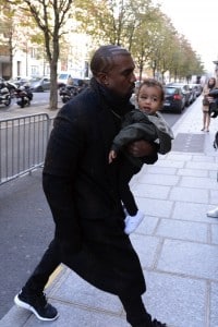 Kanye West carries daughter North West into a Paris hotel