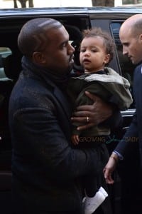 Kanye West carries daughter North into a Paris hotel
