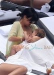 Kardashian nurses Penelope pool side in Miami