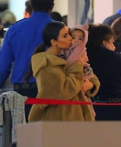Kim Kardashian kisses baby North at JFK airport