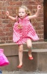 Marion Broderick plays on a stoop on the way home from school