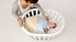 Miniguum infant bed with baby inside